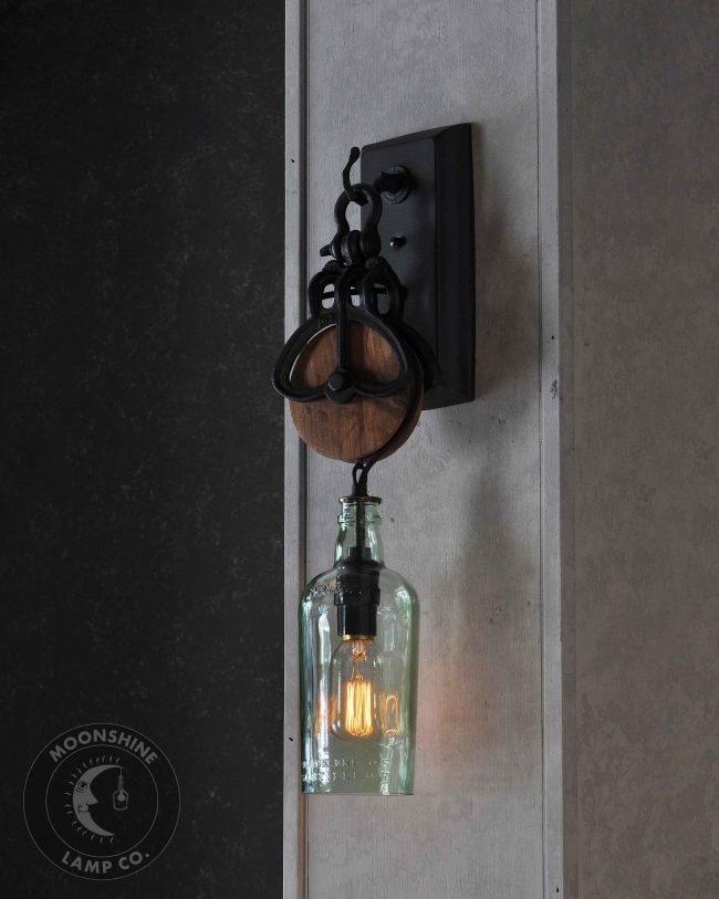 Wooden pulley wheel wall sconce
